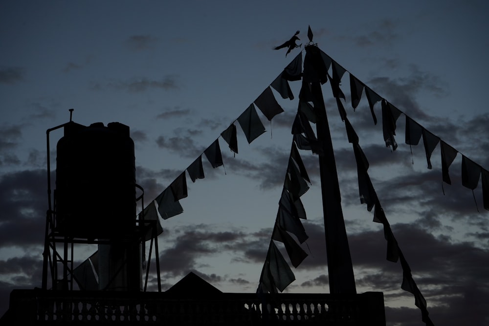 grayscale photo of flags on wooden fence