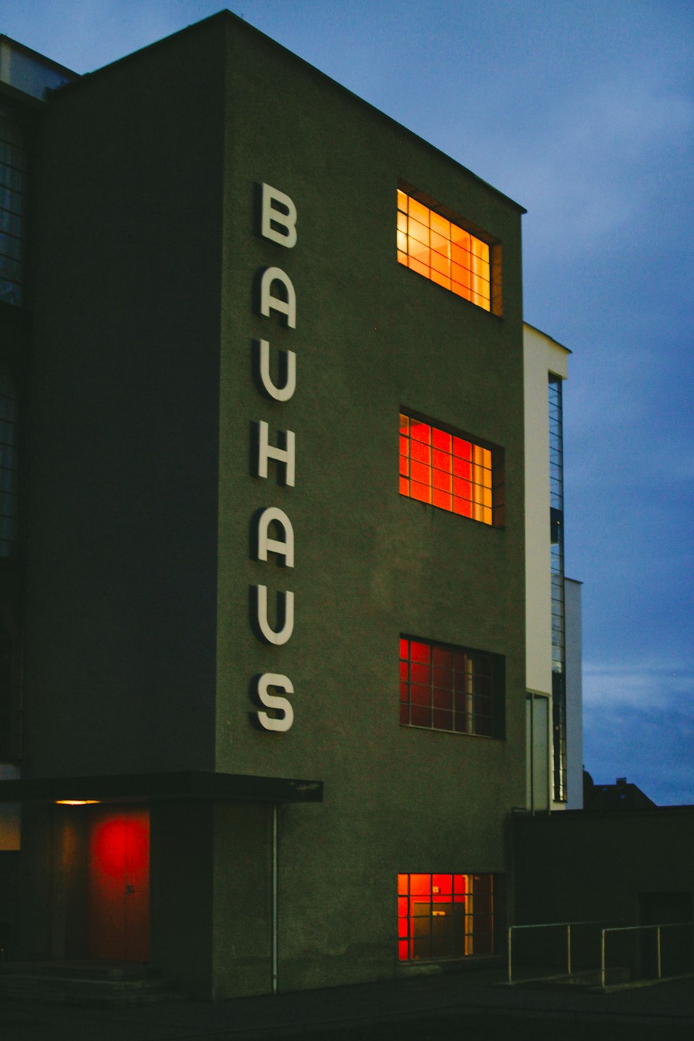 a tall building with a red light on it's windows