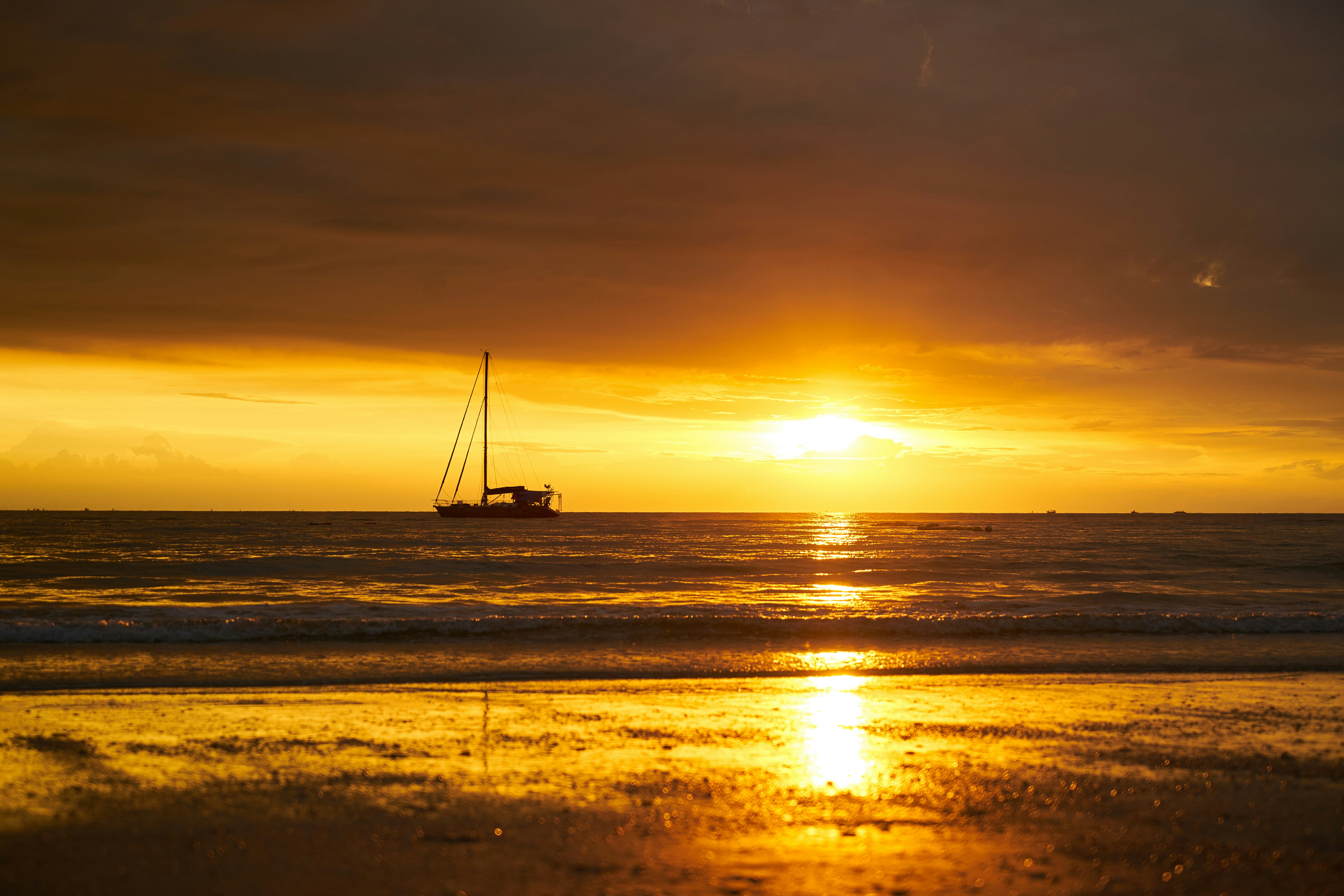 silhouette of sailboat on sea during sunset