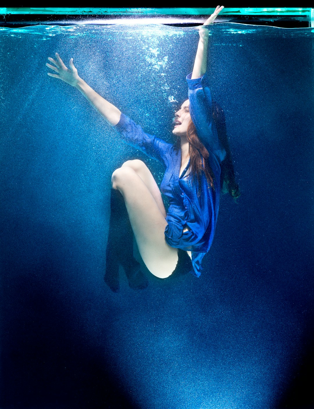 woman in blue and black bikini under water