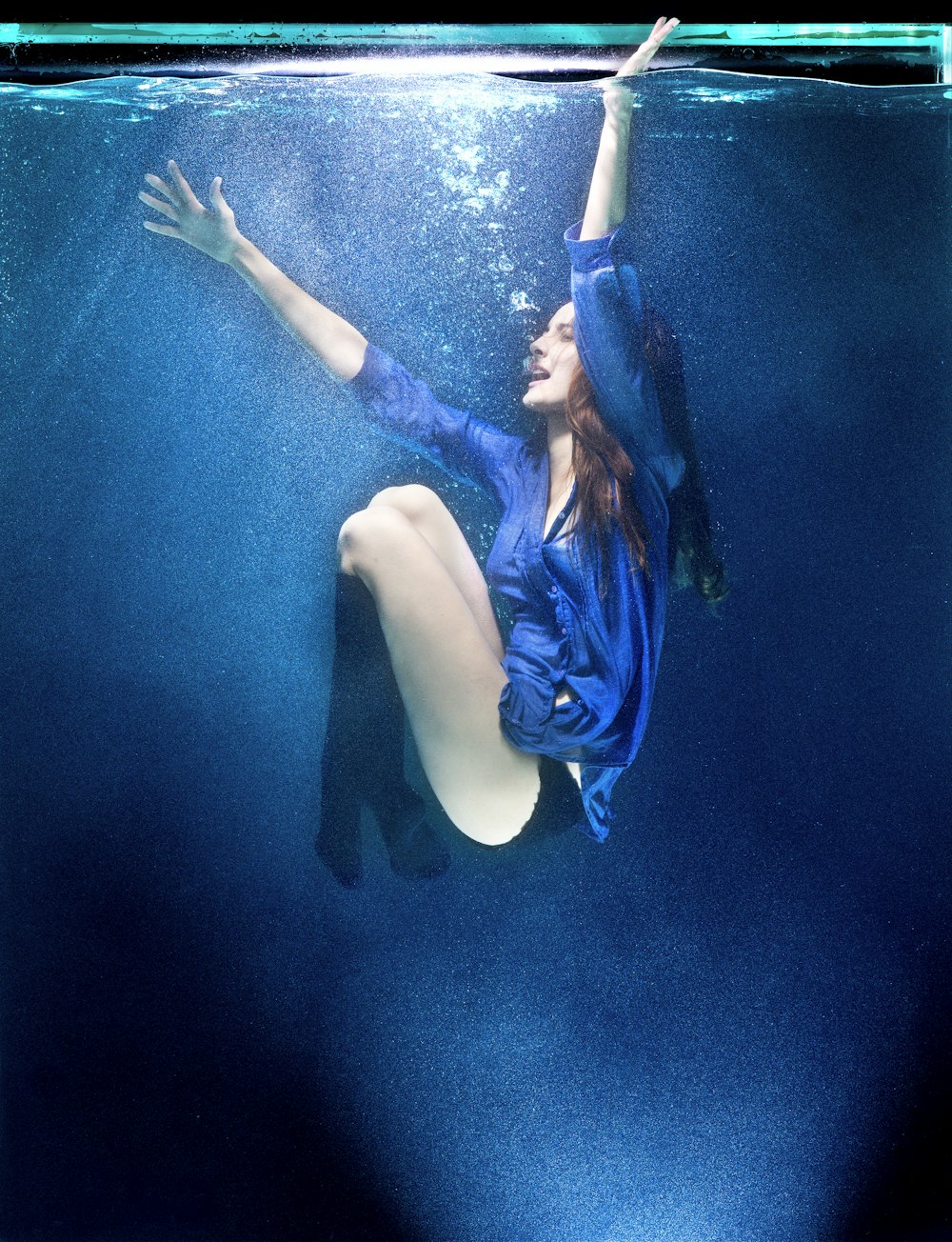 woman in blue and black bikini under water