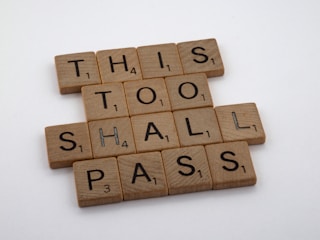 Game tiles spell out a motivational phrase using wooden letter tiles typically found in word-based board games.