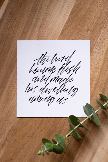 Signed certificate of authenticity resting on an olive green canvas with handwritten notes beside it.