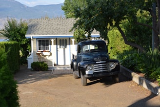 A cozy moving truck parked outside a modern home.