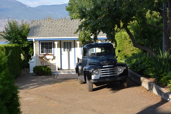 A cozy moving truck parked outside a modern home.