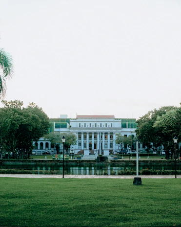 white concrete building near green trees during daytime