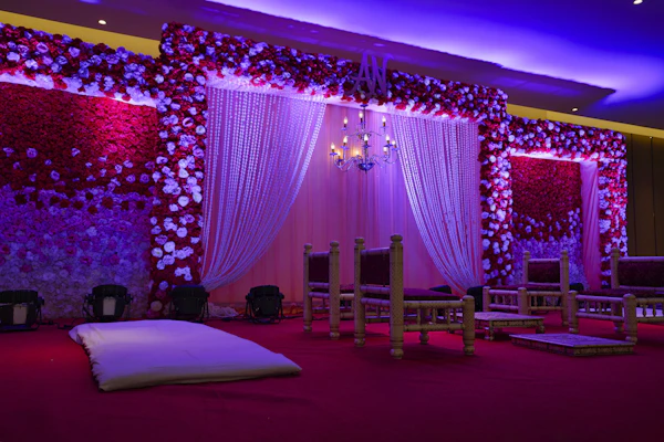Red and white wedding stage decorated with draped curtains