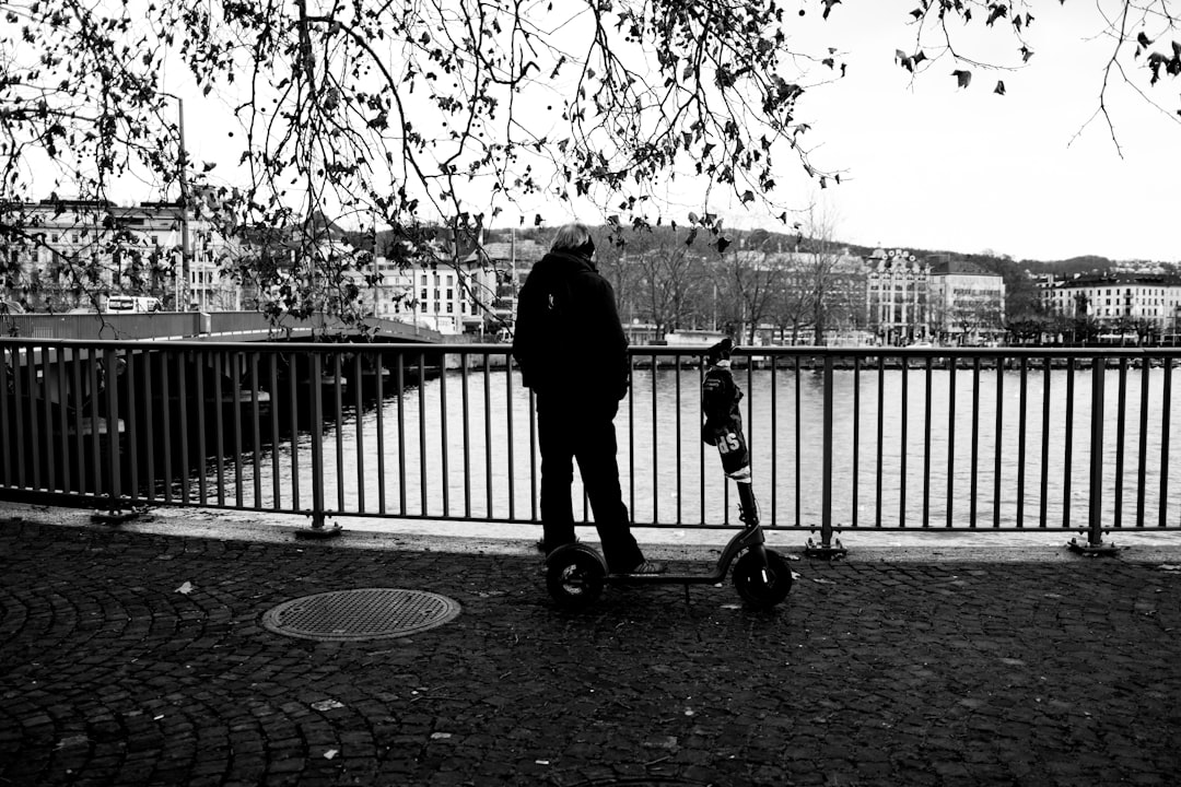 grayscale photo of person walking on pathway