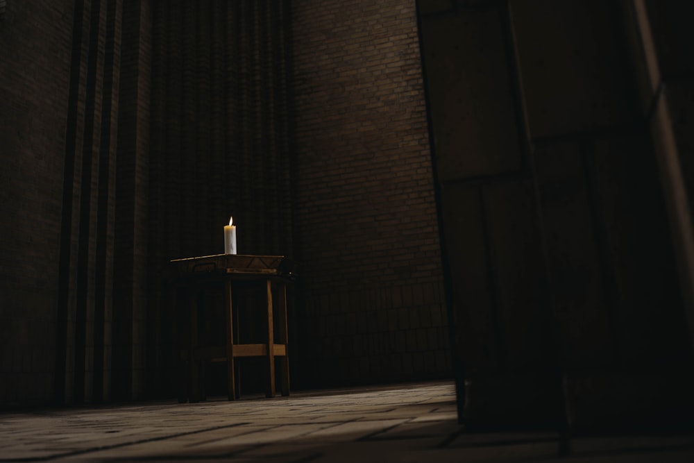 brown wooden cross on brown brick wall