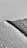 A textured surface of plastic bubble wrap is partially covered by a dark shadow, creating a striking contrast. The bubbles are evenly distributed, and the shadow adds depth and dimension.