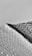 A textured surface of plastic bubble wrap is partially covered by a dark shadow, creating a striking contrast. The bubbles are evenly distributed, and the shadow adds depth and dimension.