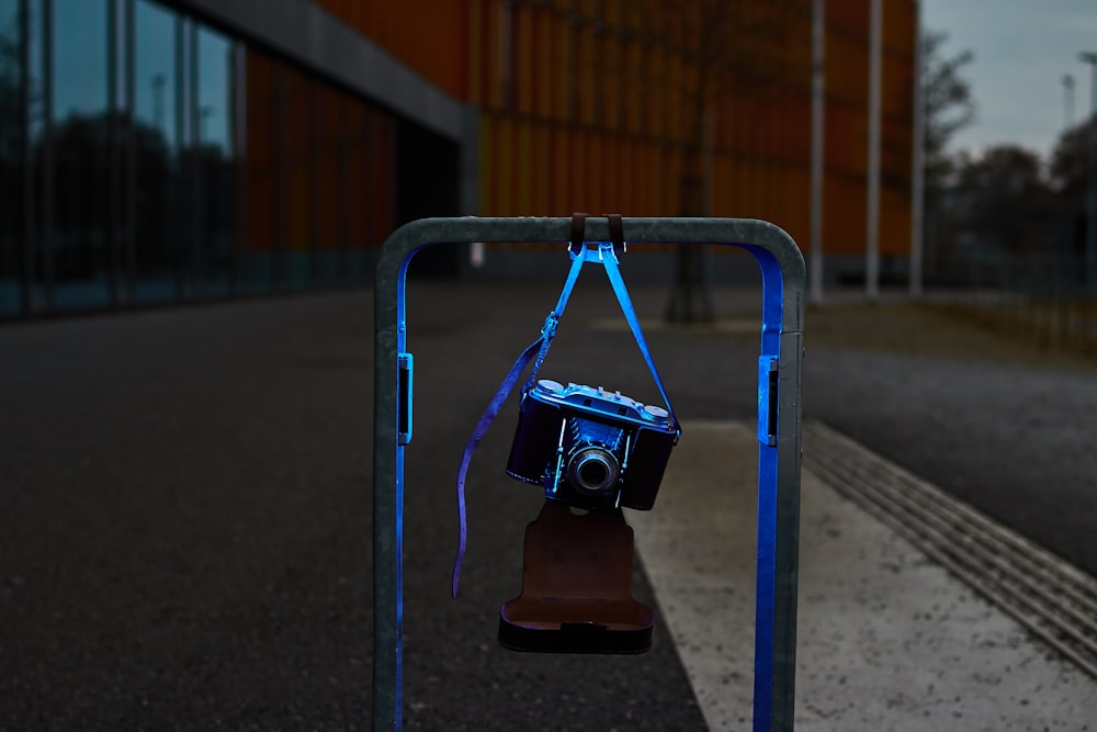 black and gray camera on gray metal stand