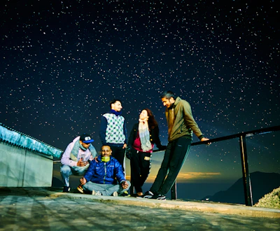 A peaceful satsang gathering under a starlit sky, sharing stories and wisdom.