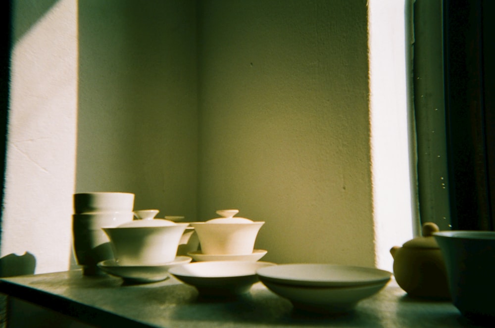 white ceramic bowls on black table