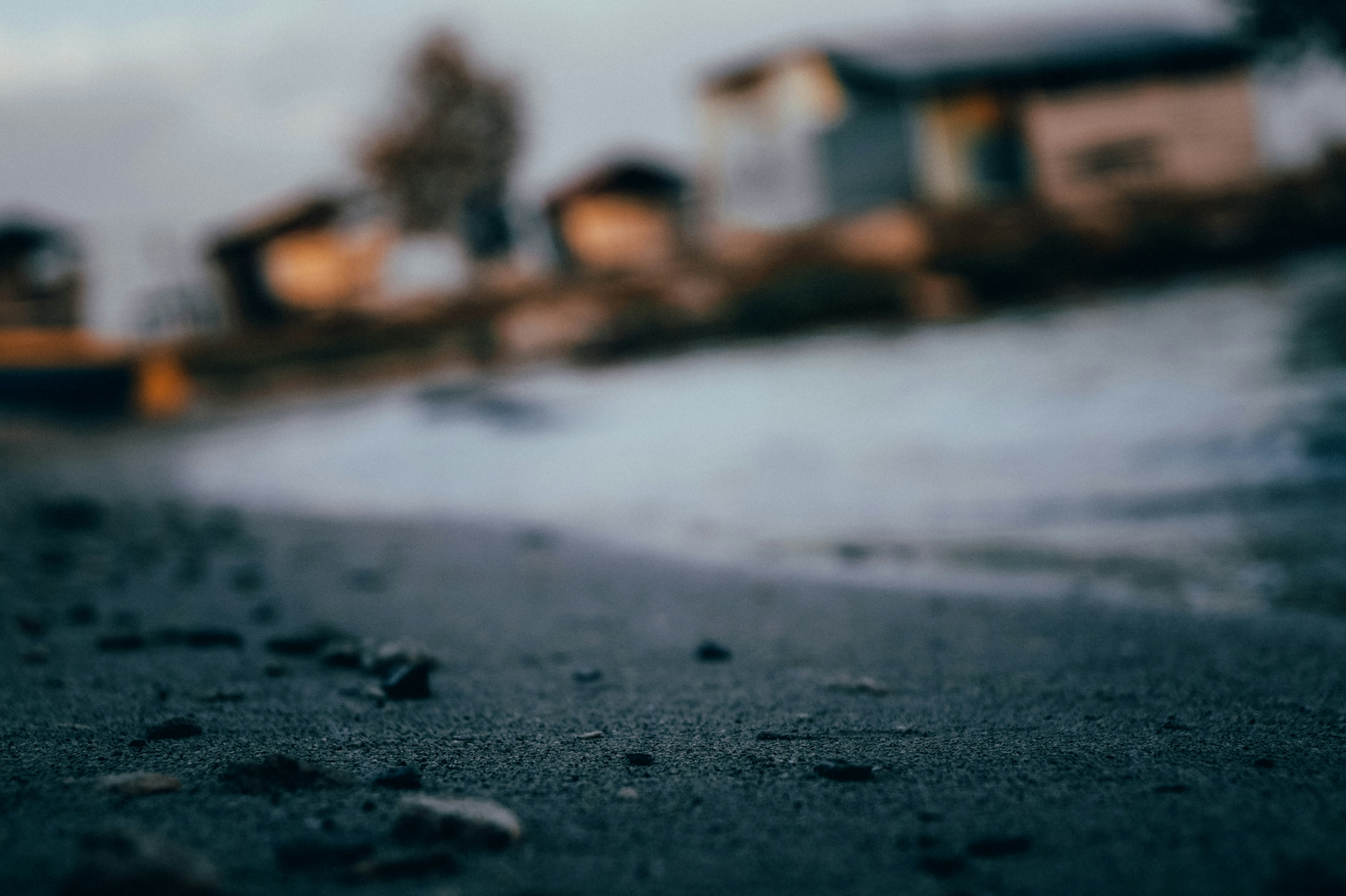 white and brown house on gray sand during daytime