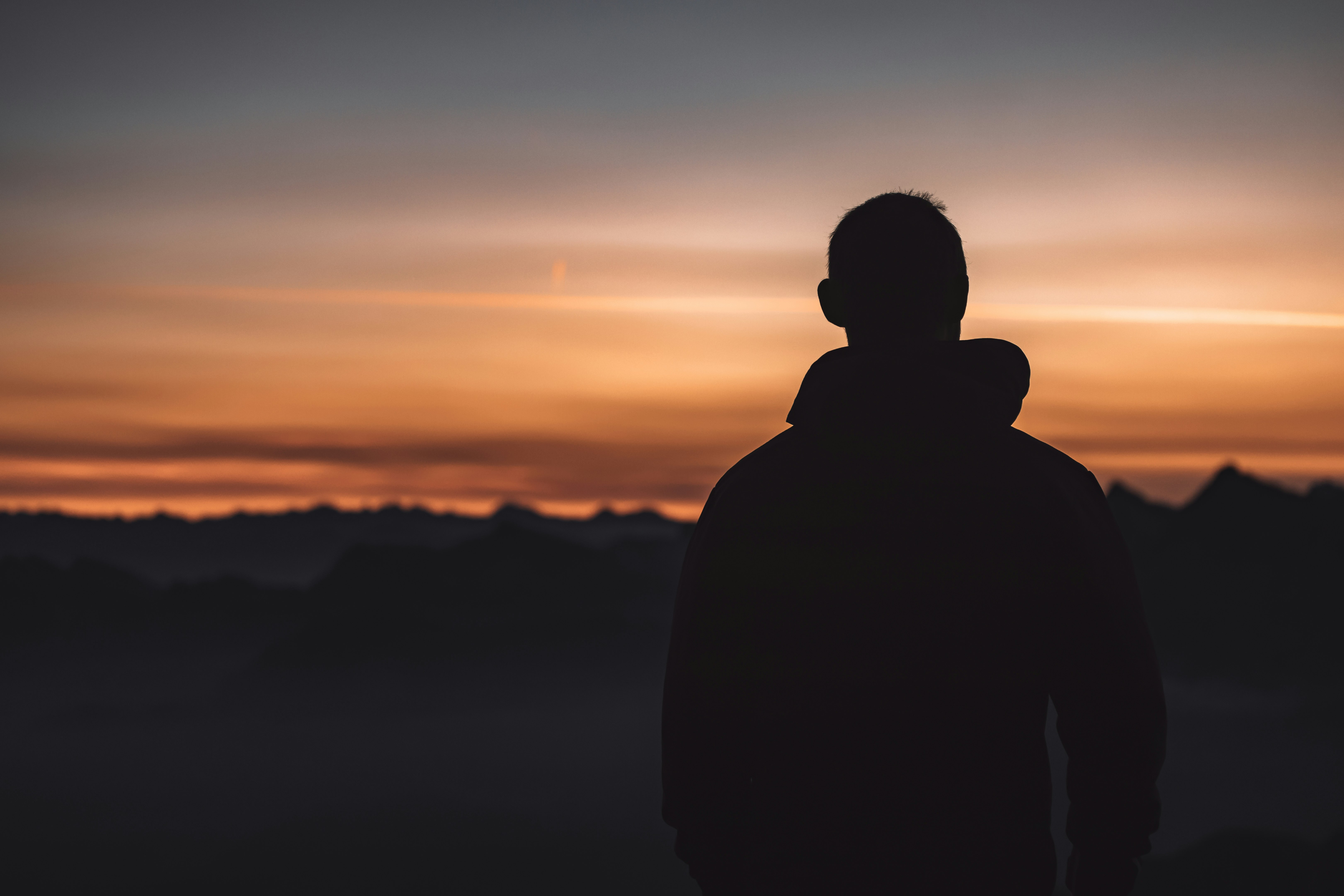 silhouette of man standing during sunset