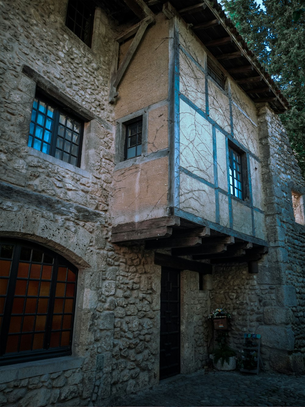 blue wooden window on gray concrete building