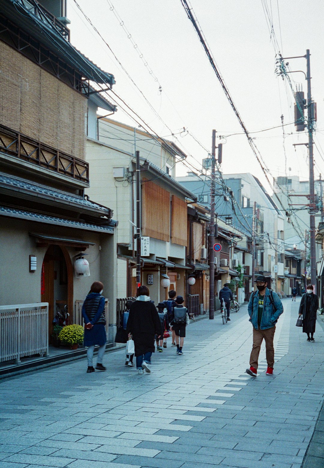 people walking on sidewalk near building during daytime