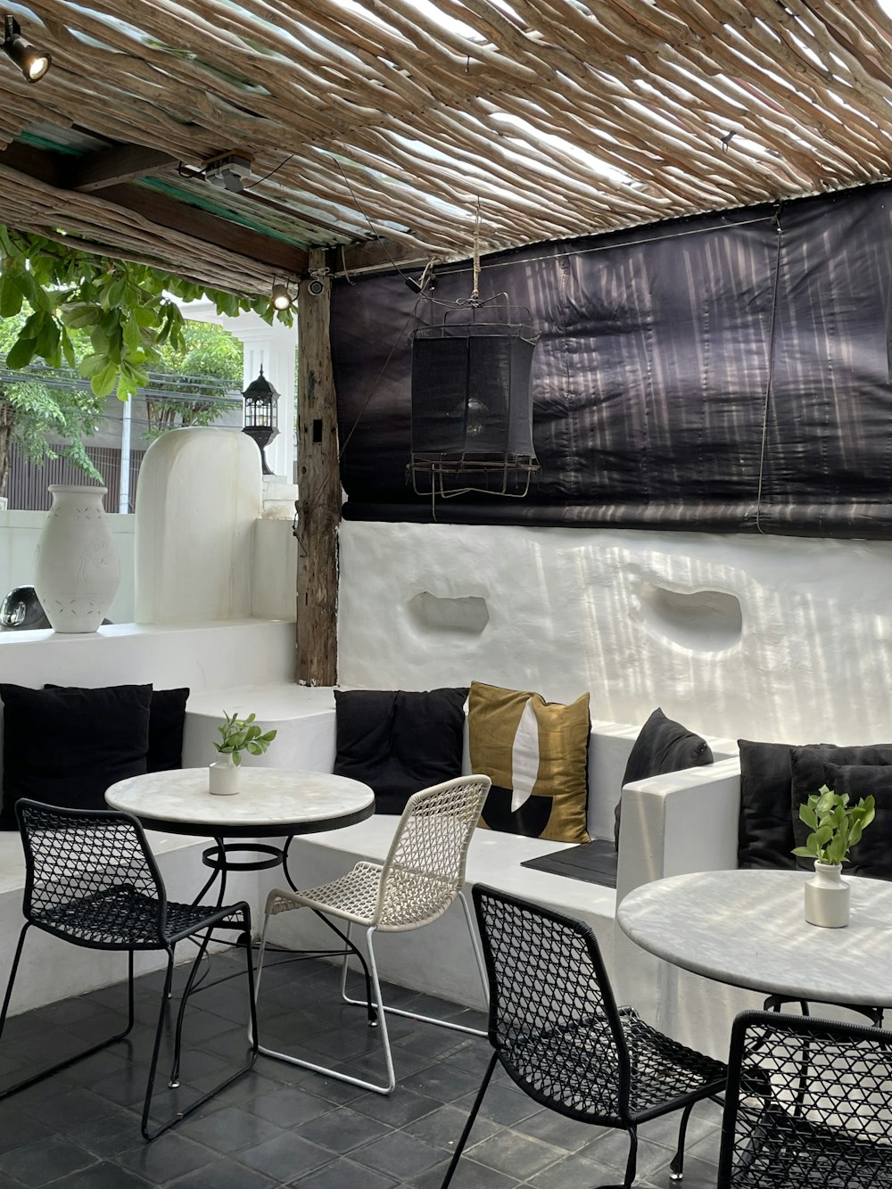 black metal framed white padded chairs and table