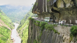 white van on road near cliff during daytime