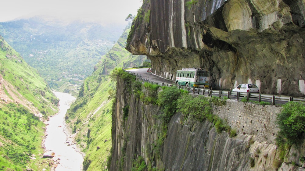 white van on road near cliff during daytime