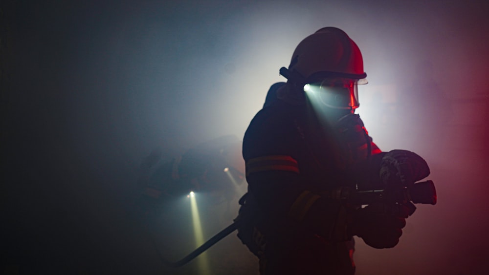 man in black helmet holding black stick