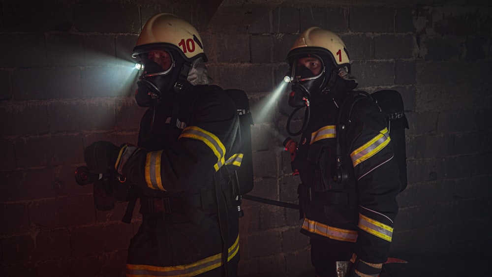 2 men in black and yellow suit wearing helmet