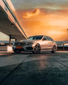 white mercedes benz coupe parked on parking lot during sunset
