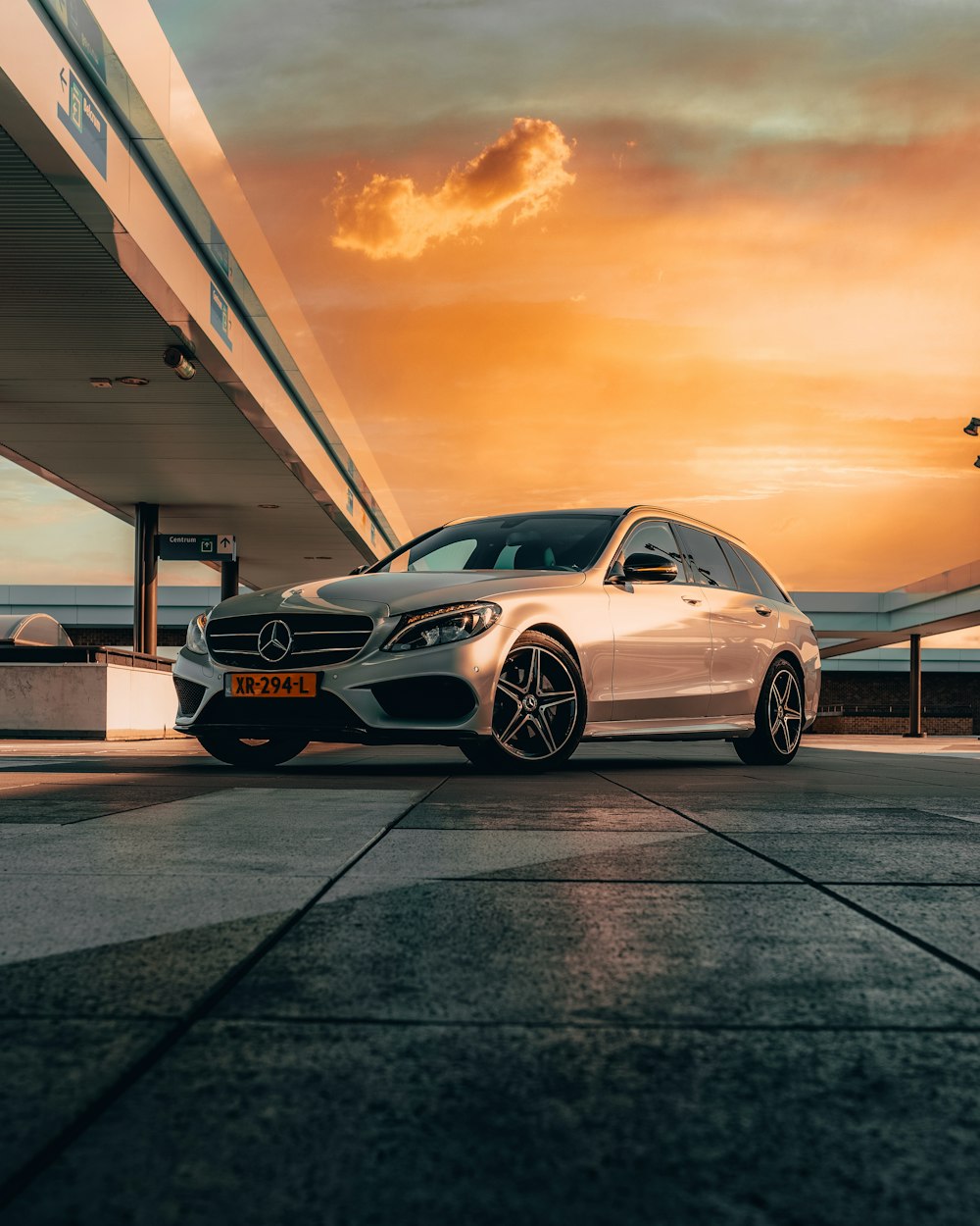 white mercedes benz coupe parked on parking lot during sunset