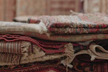 a pile of rugs stacked on top of each other