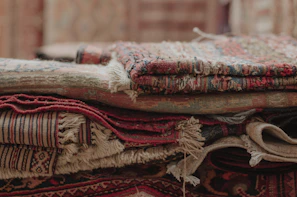 a pile of rugs stacked on top of each other