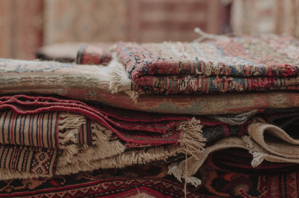 a pile of rugs stacked on top of each other