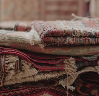 a pile of rugs stacked on top of each other