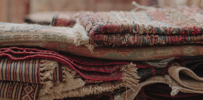 a pile of rugs stacked on top of each other