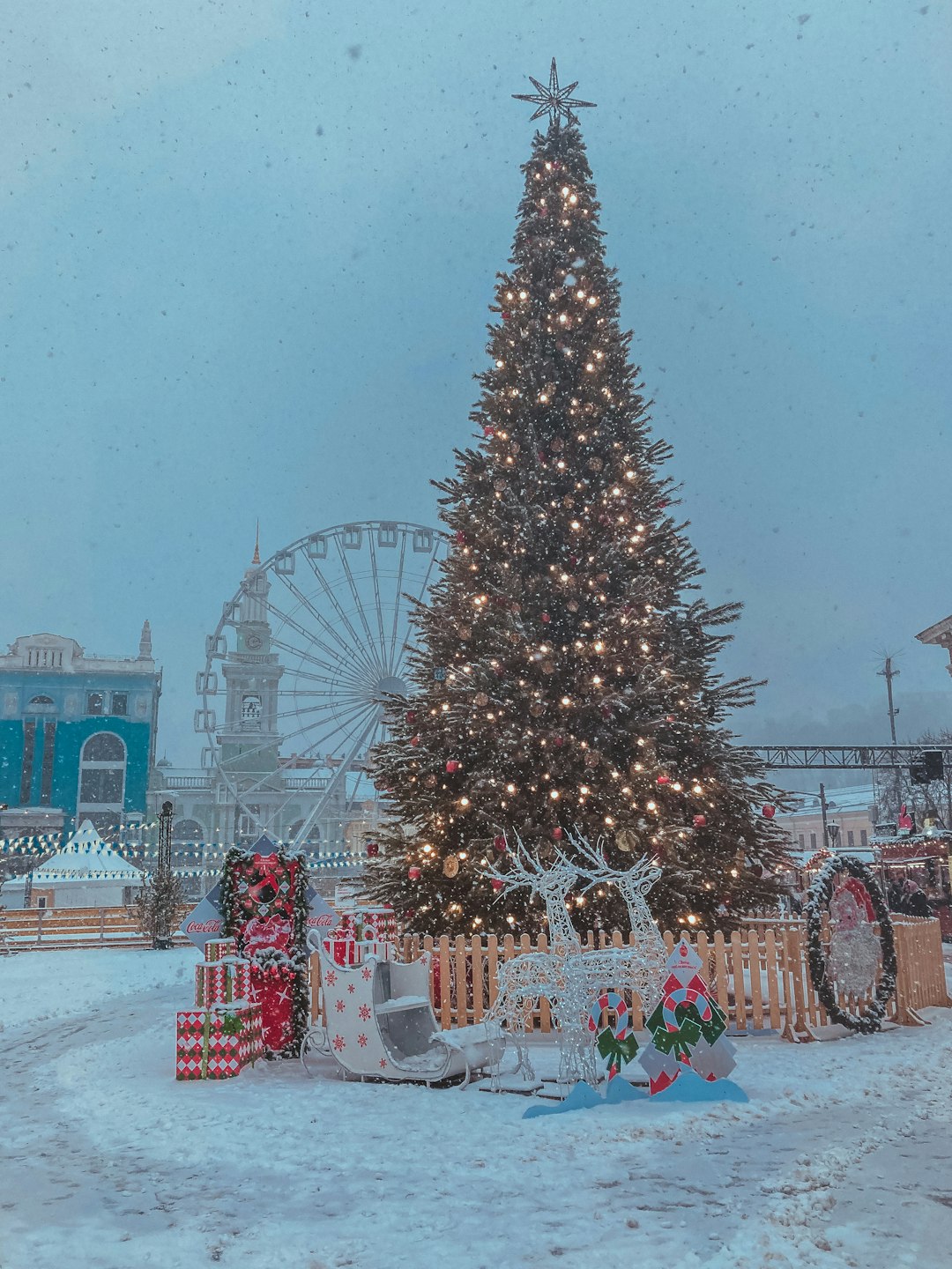 christmas tree with string lights and baubles near building