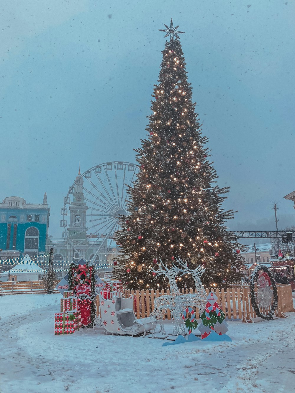 christmas tree with string lights and baubles near building