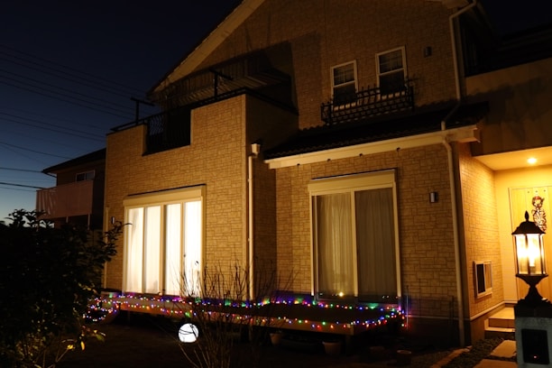 Evening view of a well-maintained Bloomington home exterior with warm porch lights glowing.