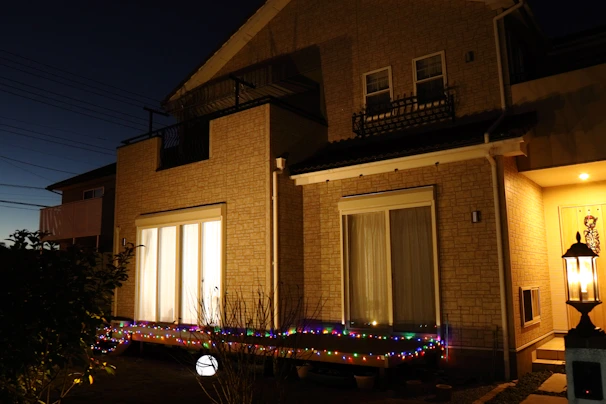 Cozy terrace house exterior with warm lighting at dusk in Melaka.