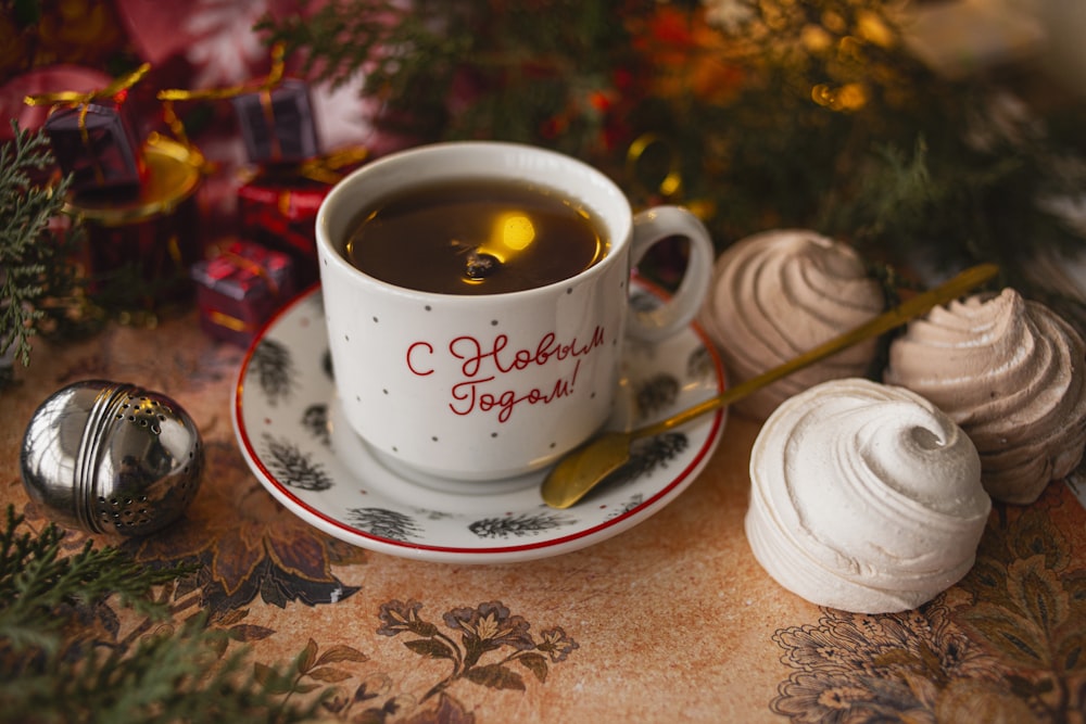 white ceramic mug with coffee on white ceramic saucer