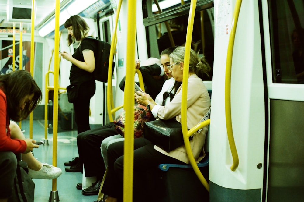 man in white shirt sitting on train