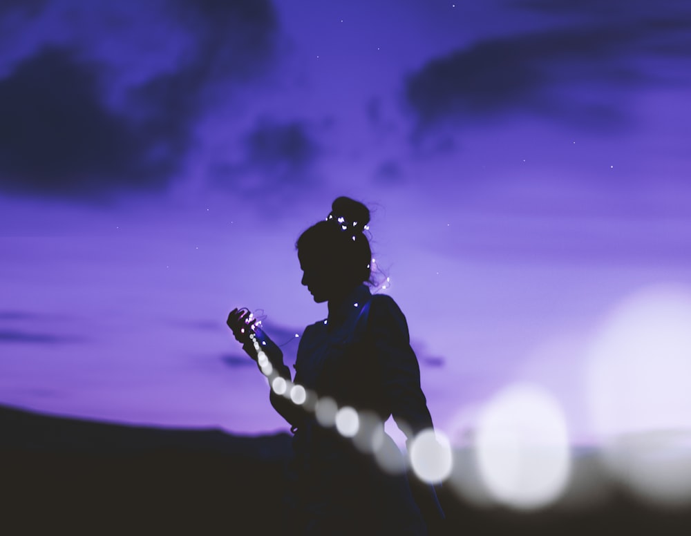 silhouette of man holding microphone