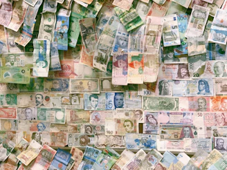 10 and 10 banknotes on brown wooden table