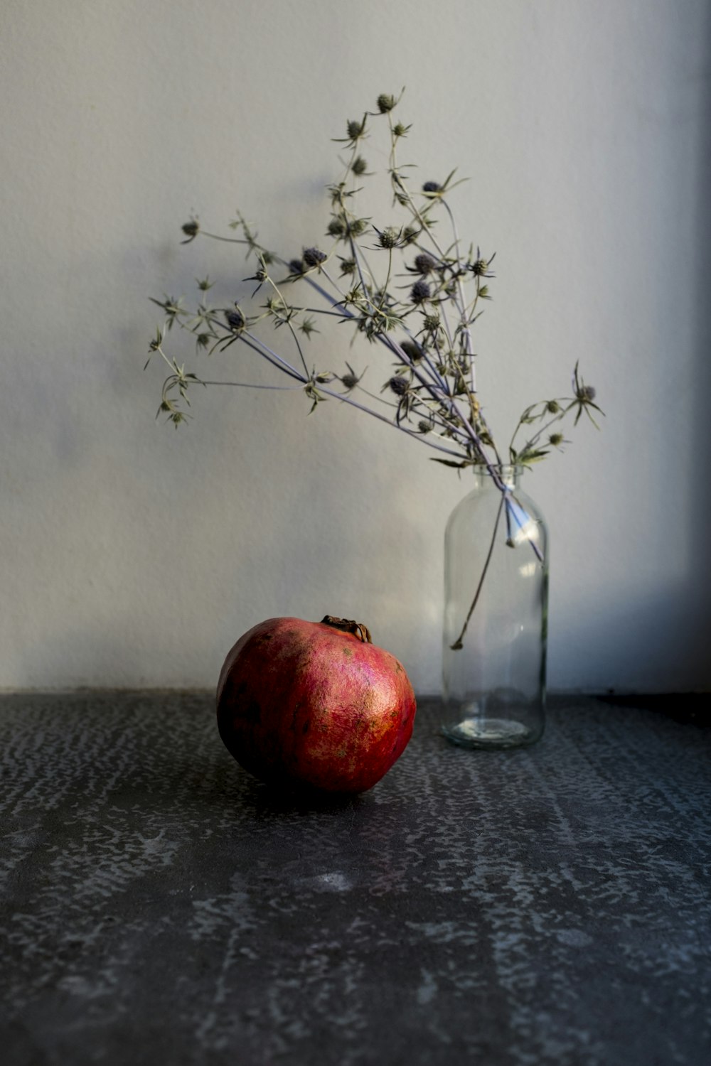 red apple fruit on clear glass vase