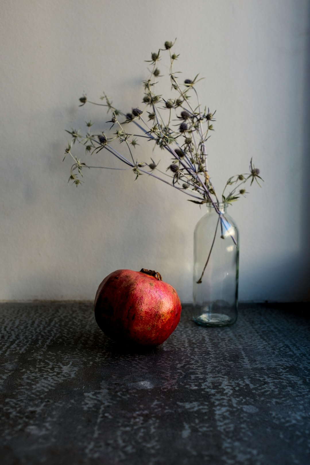 red apple fruit on clear glass vase