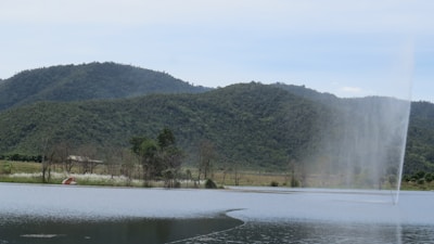 Wide shot of a serene artificial lake with Actury filtration equipment discreetly integrated.