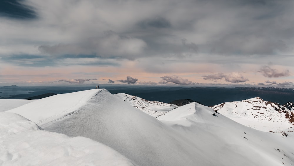 snow covered mountain under cloudy sky during daytime