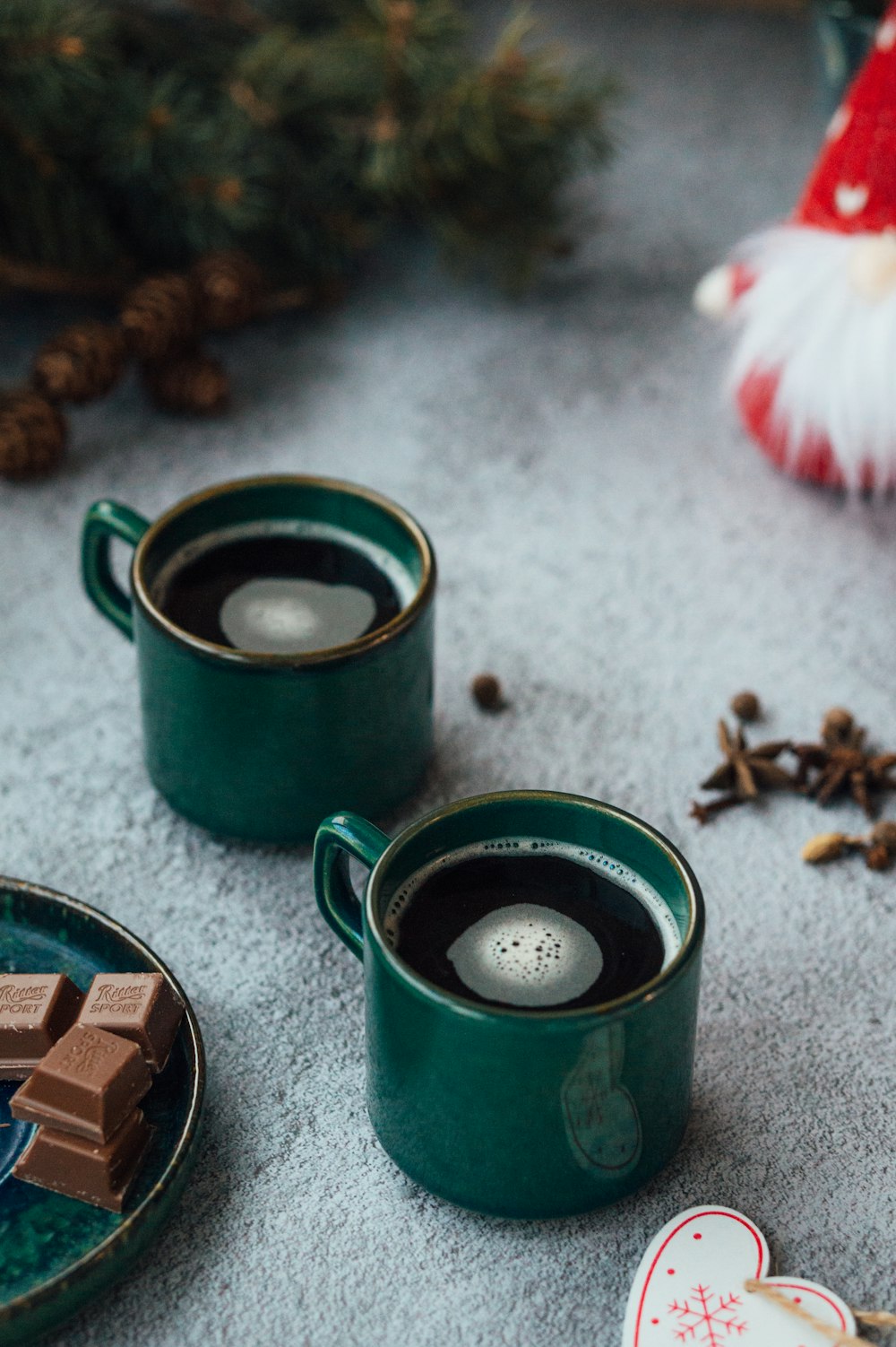 green and black ceramic mug