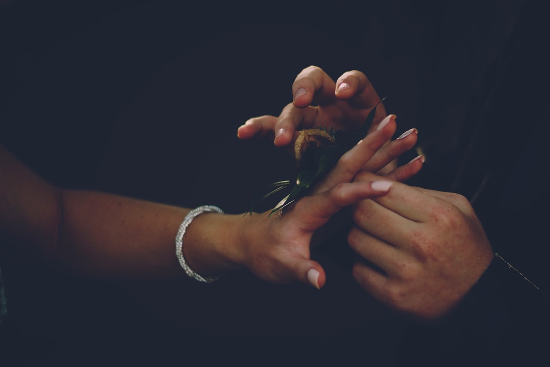 person wearing white beaded bracelet