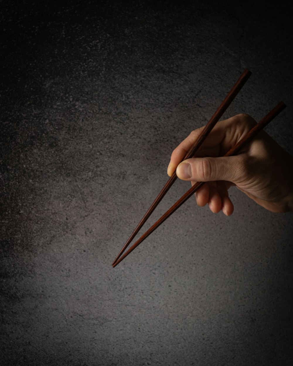 person holding brown wooden pencil