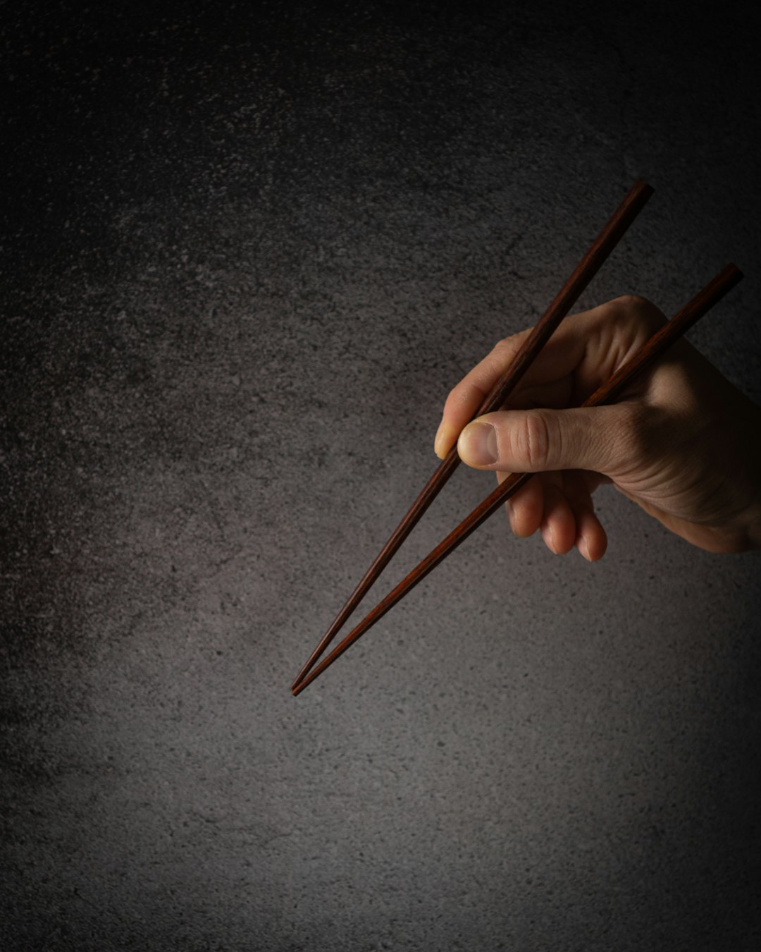 chopsticks etiquette, chopsticks, person holding brown wooden pencil